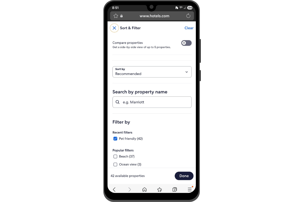 A screenshot of the Hotels.com Sort & Filter pop-out tool on mobile. Users can enable the “Compare properties” feature, set a custom “Sort by” rule, enter the name of a property, and select filters like Pet friendly, Beach, and Ocean view.