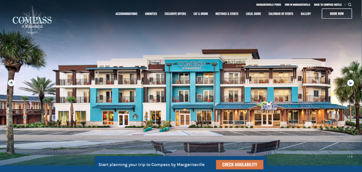 The homepage hero section for the Compass Hotel includes a full-width image slider. In this screenshot we see the entire exterior of the hotel. Below it in a blue bar are the words “Start planning your trip to Compass by Margaritaville” and an orange button that says “Check Availability”.