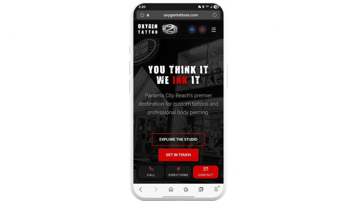 The homepage hero section for Oxygen Tattoos on mobile is a static design. There’s a photo of the shop in the background with a dark overlay. The headline reads “You Think It We Ink It” and there’s a short description that follows. There are also two call-to-action buttons — “Explore the Studio” and “Get in Touch” There’s also a sticky bar at the bottom containing three buttons: Call, Directions, and Contact (which is red).