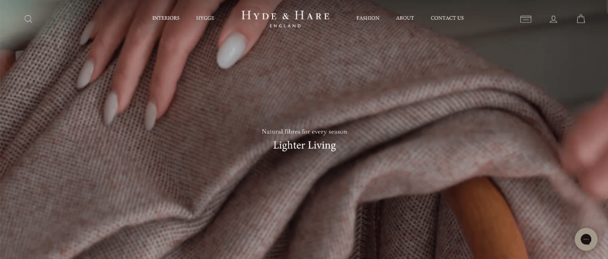 Hyde & Hare homepage A screenshot of the hero section video on the Hyde & Hare homepage shows a woman with perfectly manicured nails running her hands over a soft throw blanket.