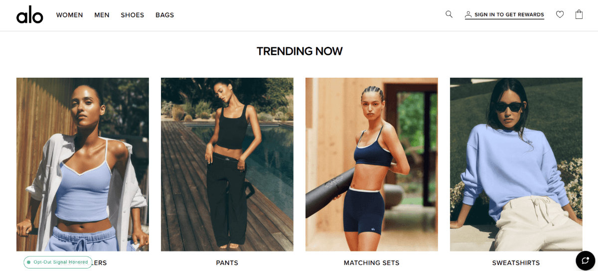 Also product imagery The “Trending Now” section on the homepage of the Alo website. There are four categories with corresponding images: Best Sellers shows a woman in a loose fitting button-down shirt and a fitted cropped tank top, Pants shows a woman wearing loose black pants, Matching Sets shows a woman in a bralette and biker shorts, and Sweatshirts shows a woman in a loose light blue sweatshirt.