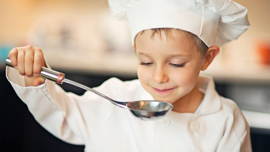 young boy with soup ladle