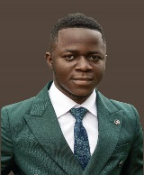 An image of author Firmin Nzaji in a green suite with a brown backdrop